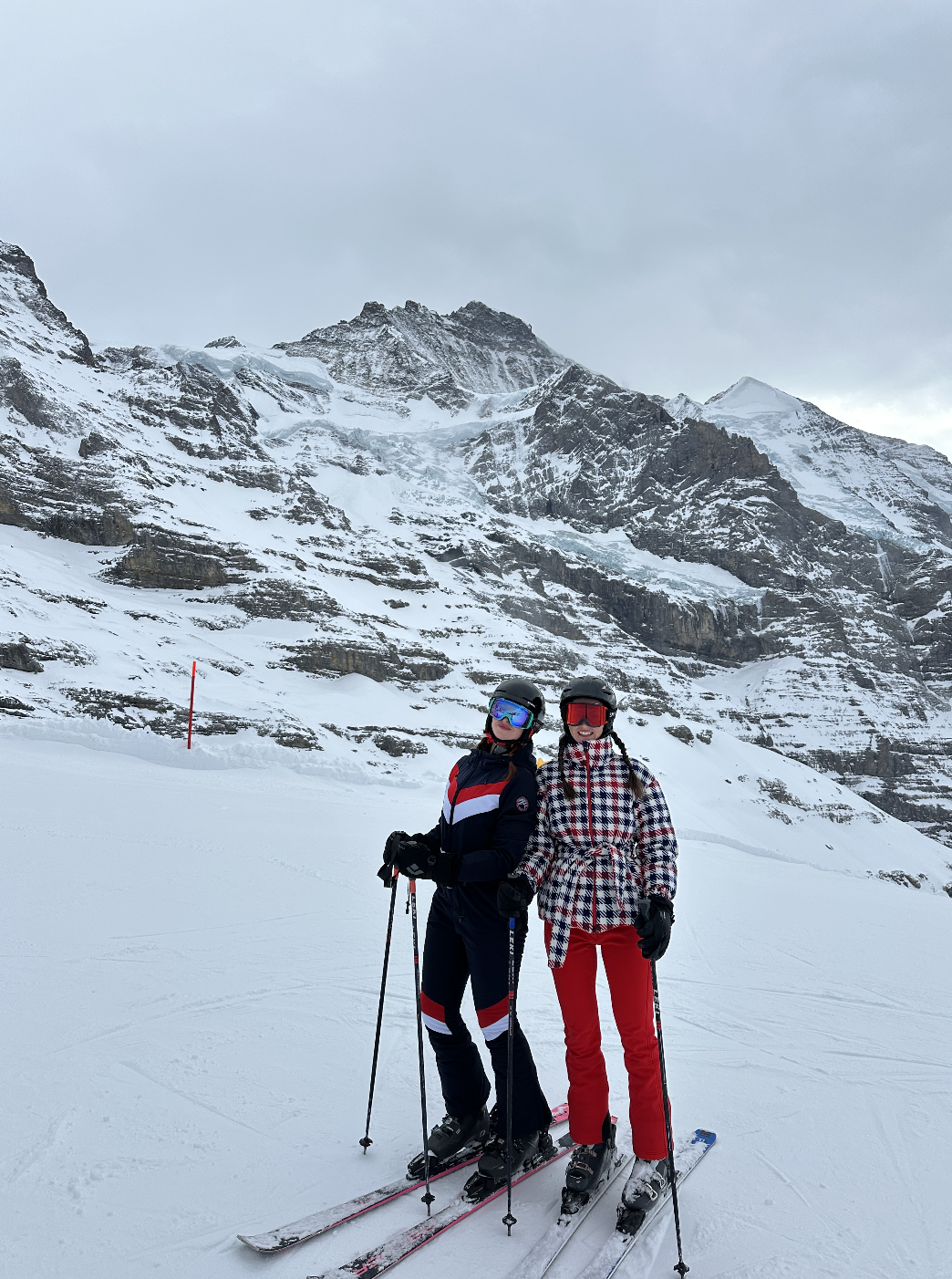 Lara and Skylar Dykstra skiing together in the mountains