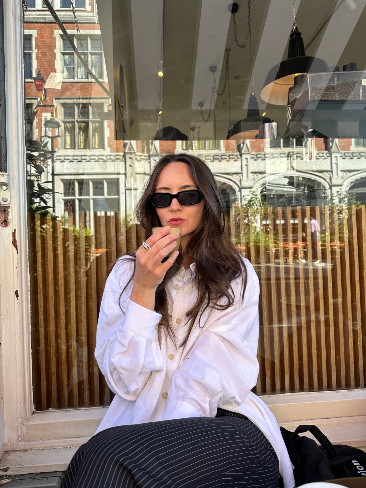 Skylar Dykstra drinking coffee outside a cafe
