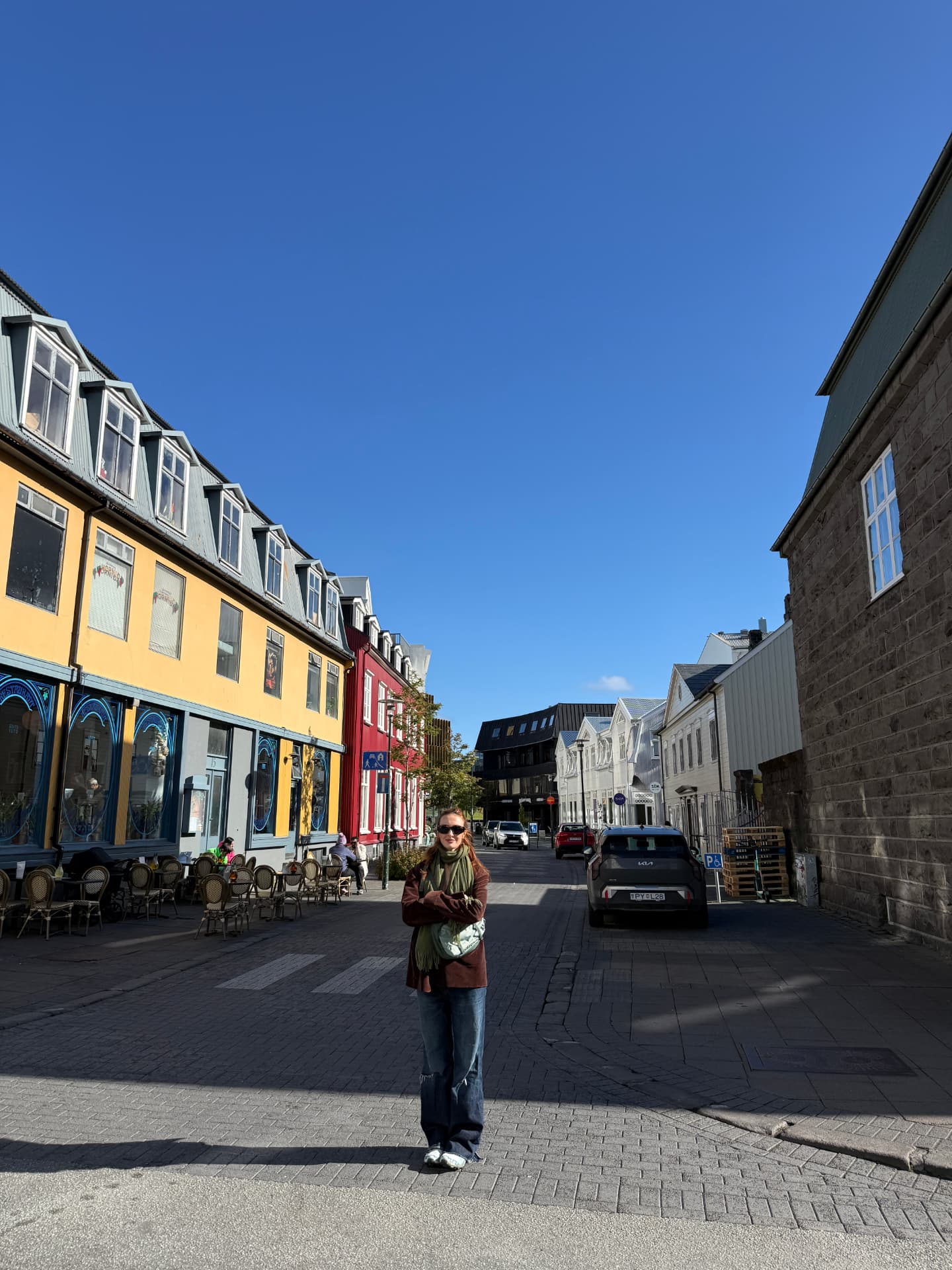 Skylar Dykstra standing in the middle of a cobblestone street in Reykjavik